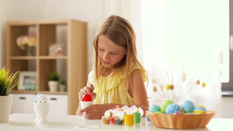 happy-girl-coloring-easter-eggs-at-home