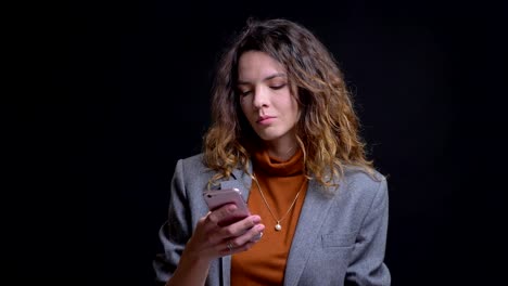 Closeup-portrait-of-young-caucasian-woman-browsing-on-her-phone-and-reacting-to-social-media-posts