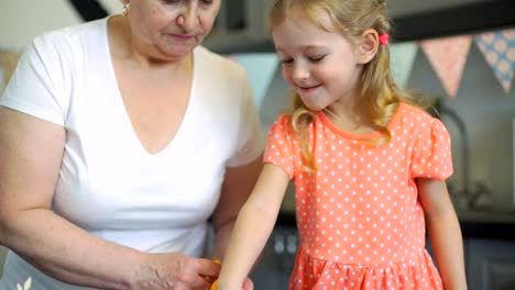 Pequeña-niña-decoración-galletas-con-la-abuela