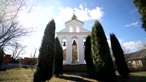 Church-bells-on-a-Sunny-day-in-a-strong-wind.-The-wind-shakes-the-trees-near-the-bell-tower-and-Sonechka-shines-in-the-cell-near-the-Church-bells