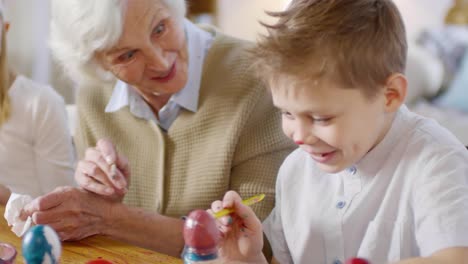 Grandmother-and-Grandchildren-Painting-Eggs-for-Easter