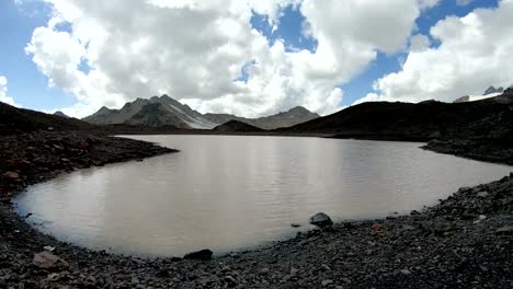 Timelapse-gorge-cliffs-and-mountain-lake-with-moving-sky-shadows