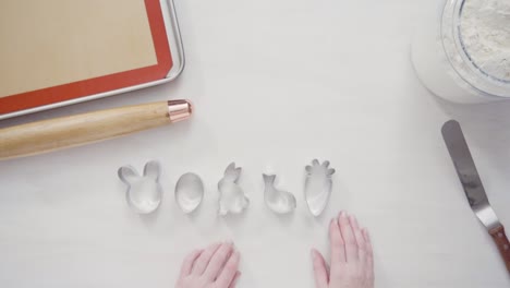 Cutting-sugar-cookie-dough-with-Easter-shaped-cookie-cutters.