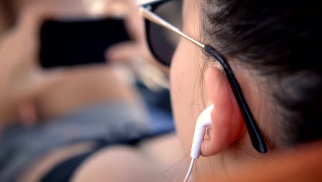 Handsome-female-teen-with-earphones-watching-movie-on-laptop-computer,-cinematic-selective-focus