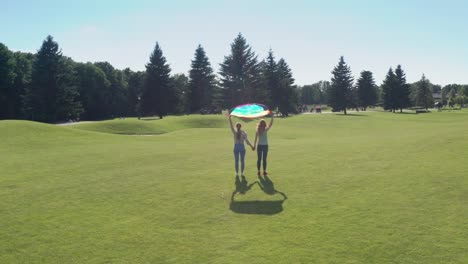 Drone-flight-over-lesbian-couple-holding-lgbt-flag