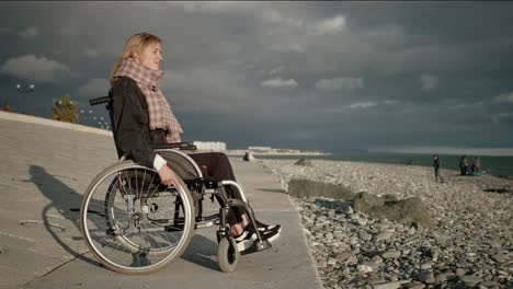 Lonely-handicapped-woman-in-wheelchair-near-the-sea