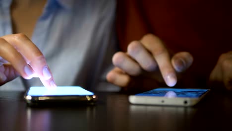 Pareja-joven-en-una-cita-sentada-en-sus-teléfonos