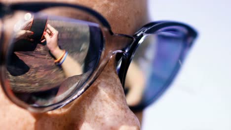 Mobile-phone.-A-woman-in-sunglasses-looks-at-a-mobile-phone.