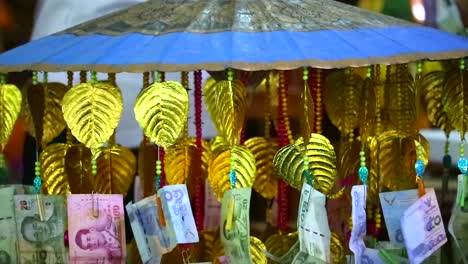 Many-Thai-banknotes-donated-by-people-decorate-with-umbrella-to-temples-in-Buddhism-event