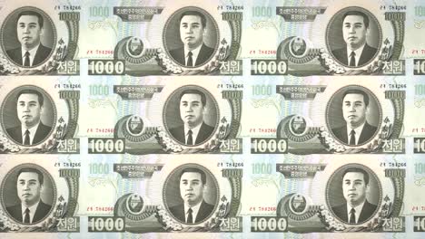 Banknotes-of-one-thousand-wons-of-North-Korea-rolling,-cash-money,-loop