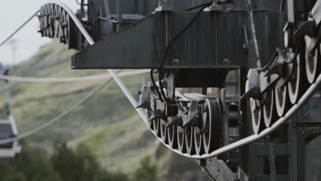 Aerial-lift-booth-riding-over-green-trees-in-rocky-mountains