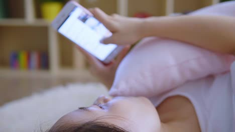 Asian-woman-using-cellphone-in-living-room