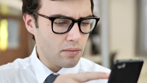 Close-Up-of-Young-Businessman-Scrolling-Smartphone