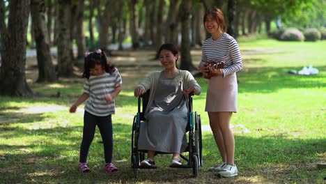 Cheerful-mother-with-two-cute-daughter-in-park