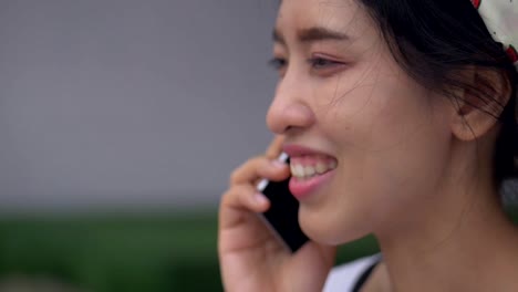 Close-Up-portrait-young-asian-woman-talking-on-phone-smiling-and-happiness.-Beautiful-young-business-lifestyle-using-technology.