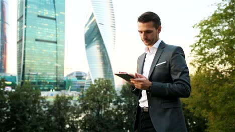 Young-caucasian-man-holding-smartphone-for-business-work.