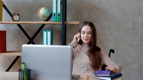 Disabled-young-woman-working-at-office