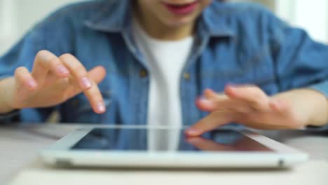 closeup-of-girl-fingers-touching-screen-of-tablet-while-playing-games-online