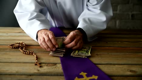 Catholic-priest-counting-money