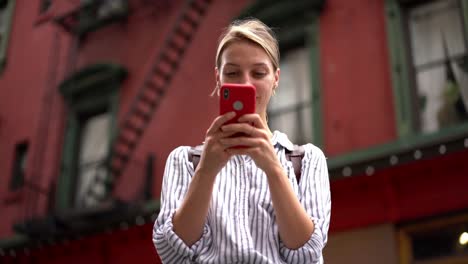 Beautiful-hipster-girl-checking-card-balance-via-banking-application-during-discover-time-in-new-city-using-public-internet-connection-on-cell-smartphone-device