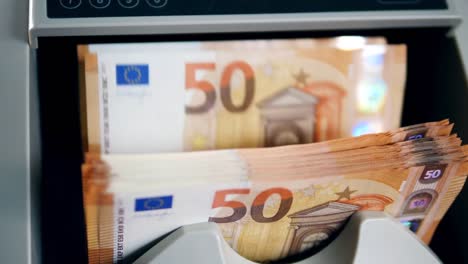 Euro-bills-are-getting-calculated-inside-of-a-machine