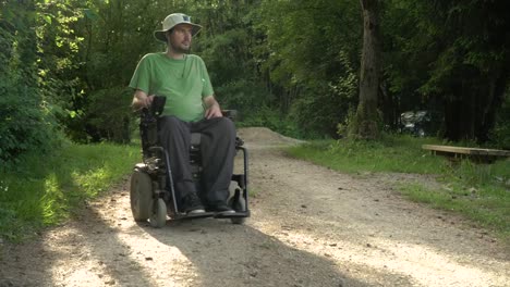 4k-resolution-portrait-video-of-a-handicapped-man-in-a-electric-wheelchair-in-nature