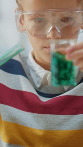 Cute-Little-Boy-in-Chemistry-Class-MIxes-Chemicals-and-Beakers,-Learning-more-about-Science.-Video-Footage-with-Vertical-Screen-Orientation-9:18