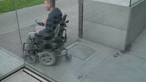 4k-resolution-follow-of-a-man-on-electric-wheelchair-using-a-ramp.-Accessibility-concept