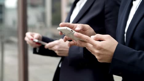 Cropped-shot-of-coworkers-using-smartphones