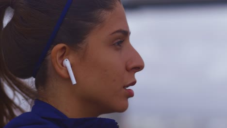 Slow-motion-close-up-of-young-woman-face-running-with-earphones