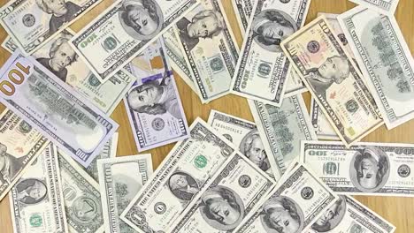 Wind-blows-away-the-dollars-from-the-table-businessman.-Paper-money