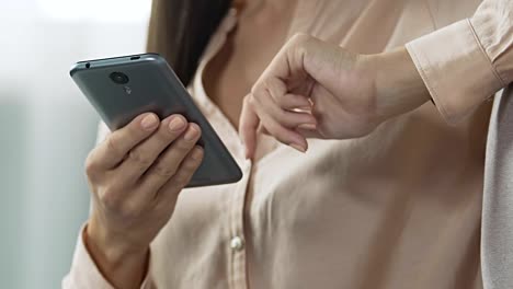 Woman-is-bored-sitting-in-living-room-scrolling-social-networks-and-reading-news