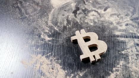 the-wooden-bitcoin-symbol-lies-on-a-dusty-table