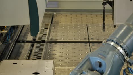 Robot-arm-in-a-metal-factory-picks-up-metal-plates