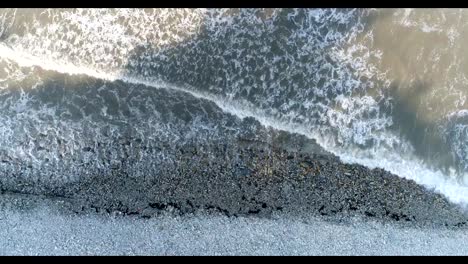 Aerial-photography,-seashore,-rocky-beach,-dark-ocean-waves.