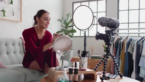 Pretty-woman-recording-a-vlog-applying-make-up