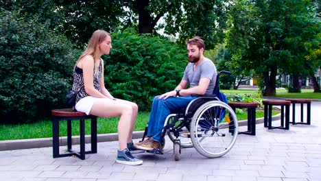 Young-disable-man-with-his-wife-sitting-in-the-park