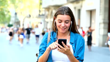 Girl-choosing-and-listening-to-music-outdoor