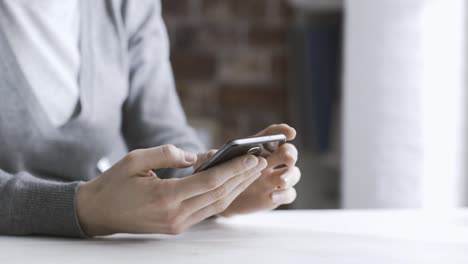 Woman-chatting-with-her-smartphone-at-home