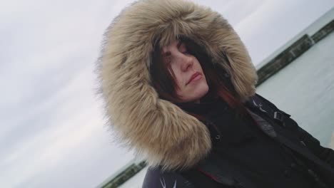 Closeup-portrait-of-a-young-beautiful-red-haired-woman-outdoors.-Girl-in-a-warm-fluffy-jacket