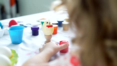 Little-Girl-Having-Fun-while-Painting-Easter-Egg