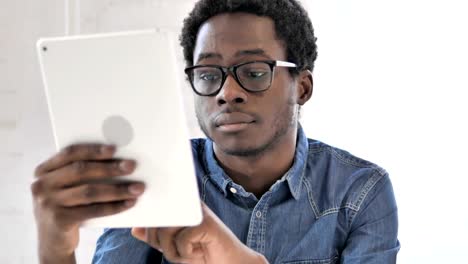 African-Man-Typing-Email-on-Tablet