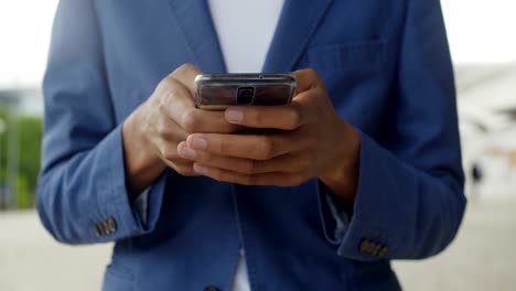 Front-view-of-male-hand-using-modern-smartphone.