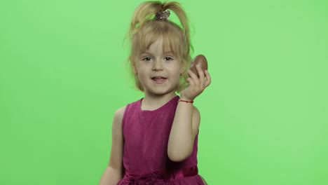 Girl-in-purple-dress-with-chocolate-egg.-Happy-four-years-old-child.-Chroma-Key