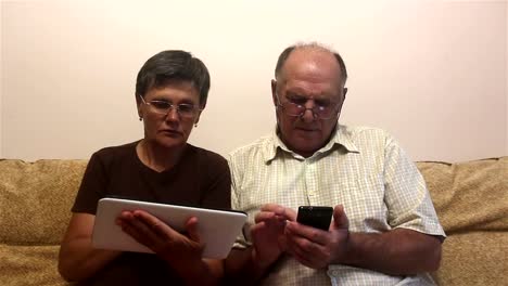 Attractive-adult-woman-and-adult-man-work-on-tablet-pc-and-smartphone.