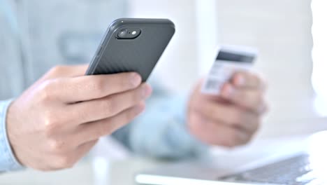 Close-Up-of-Hands-using-Credit-Card-on-Smartphone