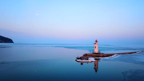 Aerial-winter-view-of-the-Tokarevskiy-lighthouse---one-of-the-oldest-lighthouses-in-the-Far-East,-still-an-important-navigational-structure-and-popular-attractions-of-Vladivostok-city,-Russia.