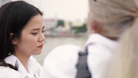 Asian-lesbian-couple-talking-while-standing-on-the-bridge.-Beautiful-Asian-women-traveling-with-girlfriends-lifestyle-holiday.