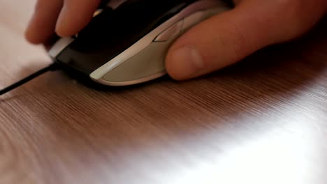 Man-hand-clicking-computer-mouse.-Mouse-in-hand-businessman.-Closeup.