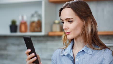 Smiling-domestic-woman-chatting-use-smartphone-eat-cucumber.-Medium-close-up-shot-on-4k-RED-camera